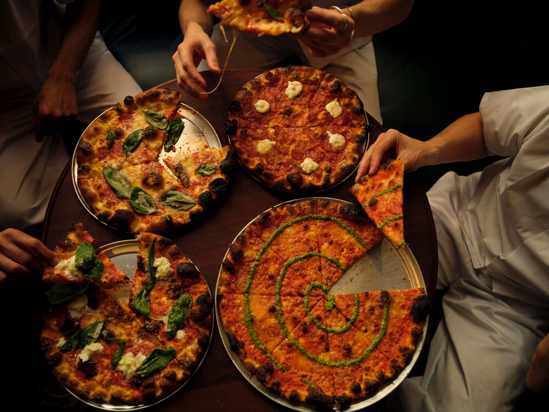 Crisp — overhead spread of thin-base pizzas including the Vecna at the Mayfair restaurant